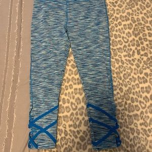 multicolored athletic leggings with crisscrosses on the bottom